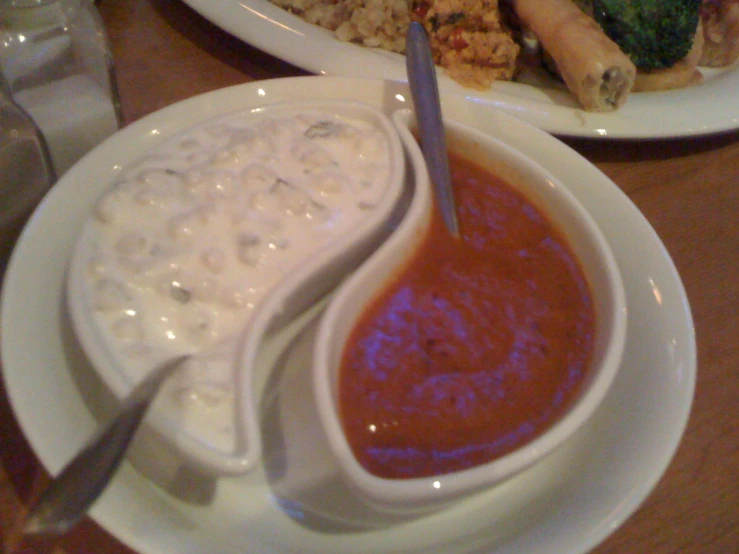 a plate of food with a salad and meatball roll