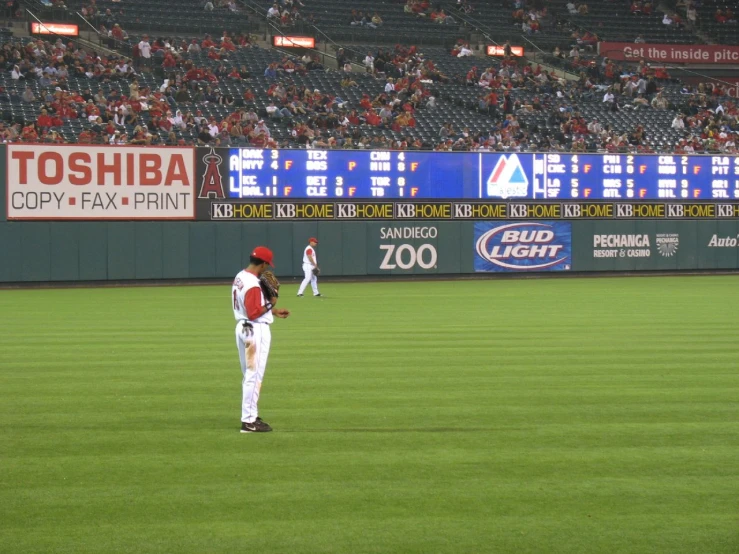 a baseball player is walking across a field