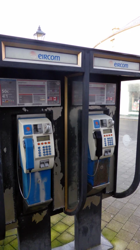 a couple of old parking machines next to each other