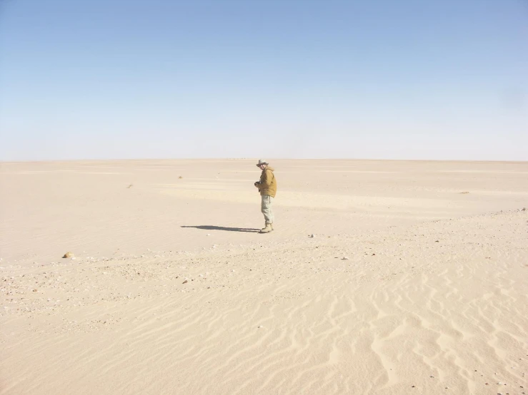 a man is walking across the big field