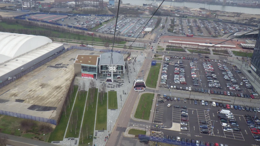 an aerial view of a parking lot, with cars parked in the lot