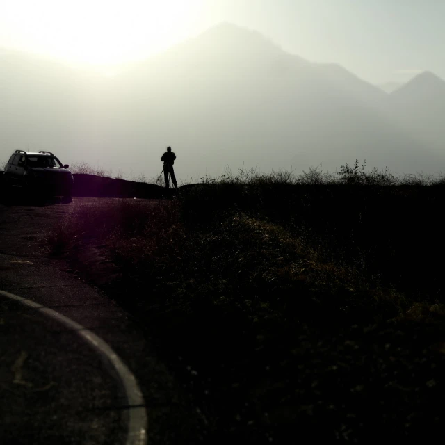 the silhouette of a person in a field is shown