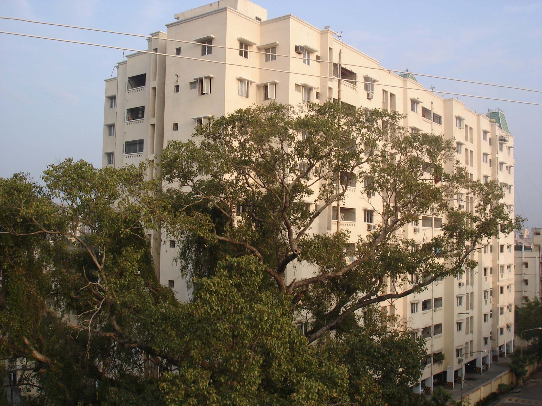 an apartment building with many windows near trees