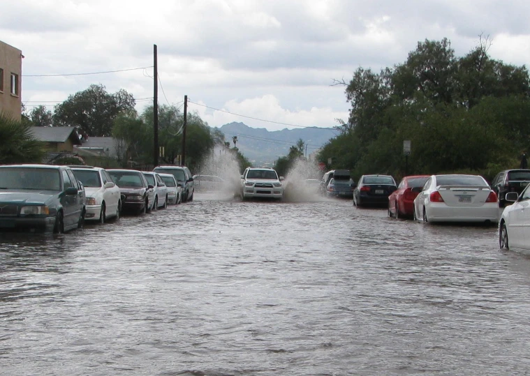 cars are stuck in the water in a flooded parking lot