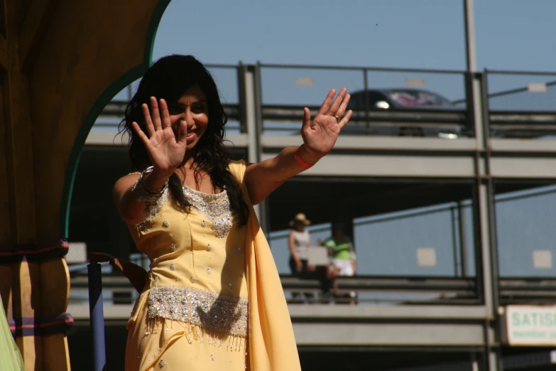 a woman is giving a wave on a stage