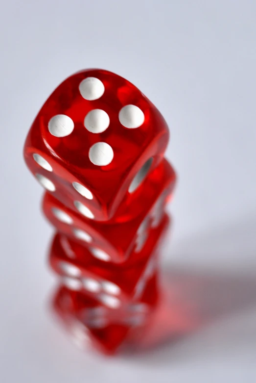 two red dices stacked together on top of each other