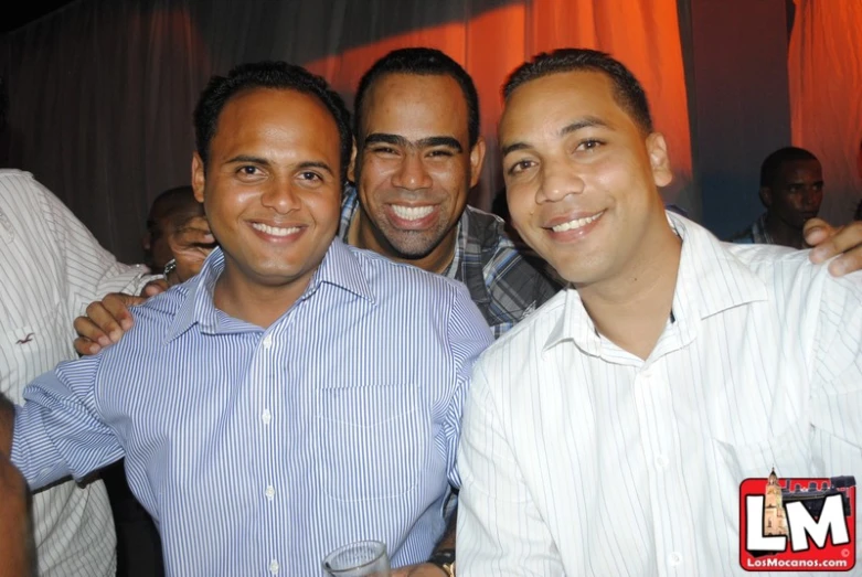 several men posing for a picture at a party