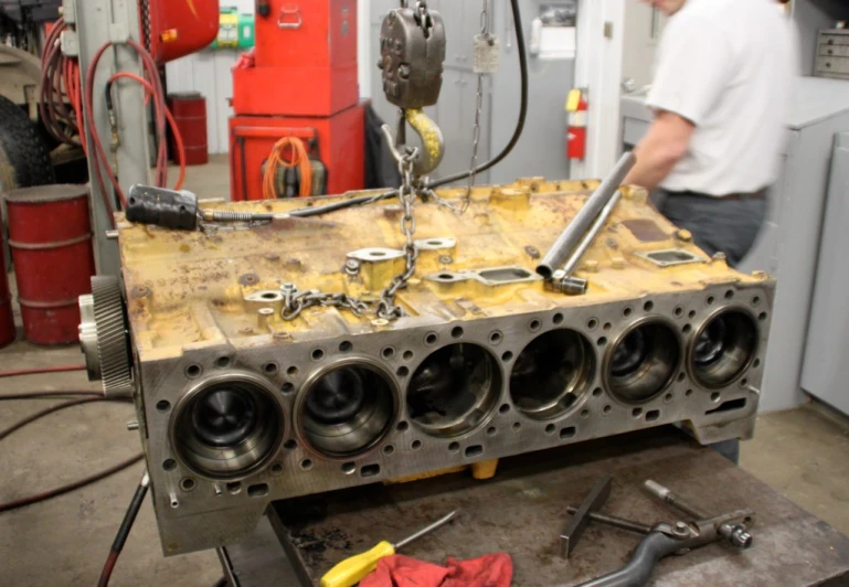 a man working with tools on metal object