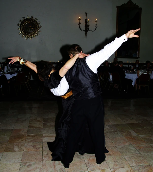 a man and woman dancing at a wedding