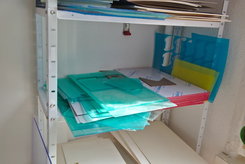 a very narrow room with a shelf full of sheets