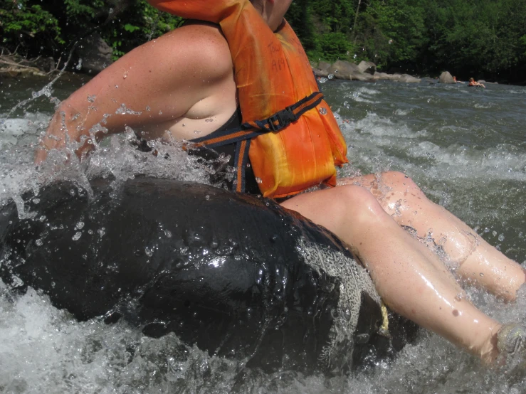 a person rides on an inflatable tube over a river