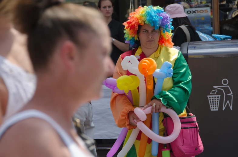 two women are standing together with a bunch of balloons