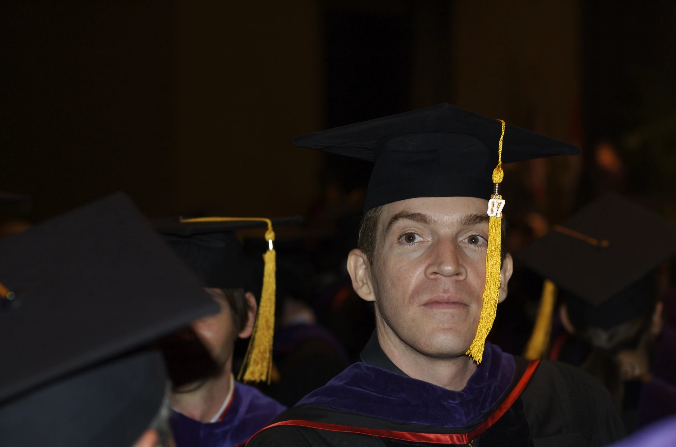 male graduate in graduation gown at commencement