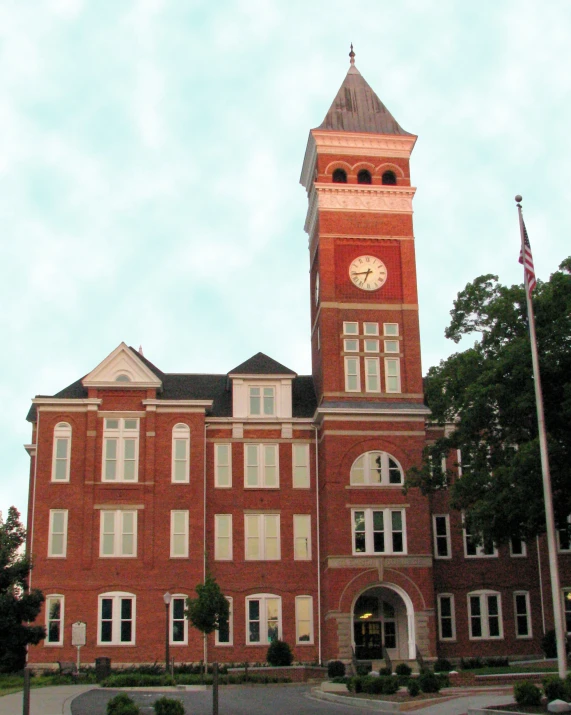 a large brick building with a clock on the tower