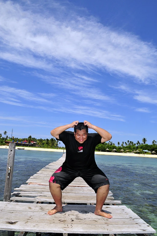 a person on a wooden dock in the water