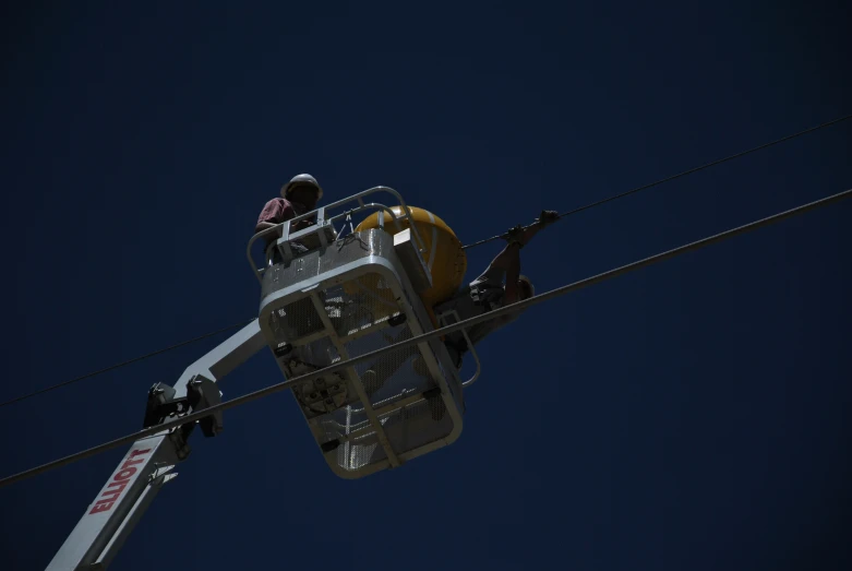 a person standing in the lift looking up at the sky