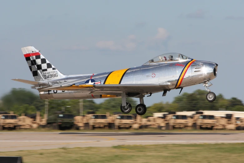 an old airplane is flying on the runway