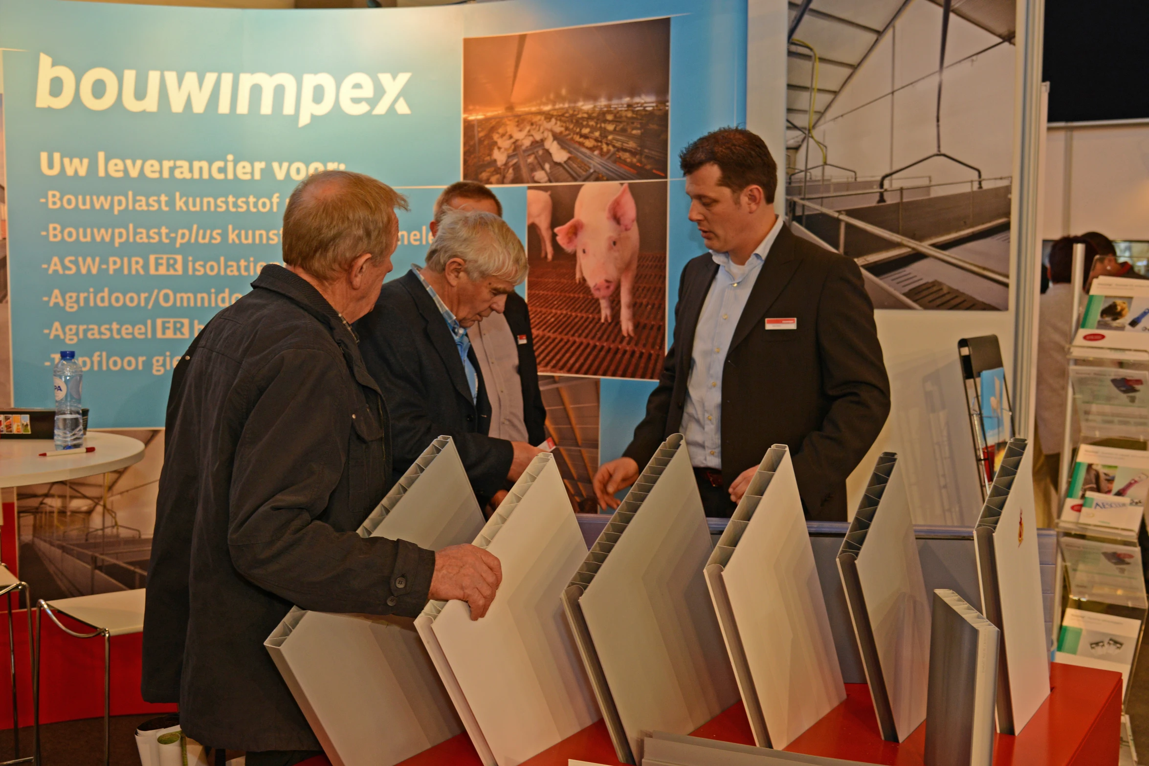 four people standing next to each other by brochures
