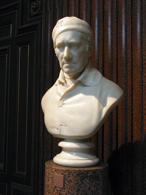 a bust of aham aham with a tie and suit on