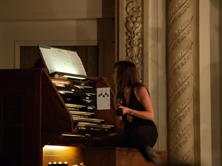 a woman on a pipe organ looking for notes