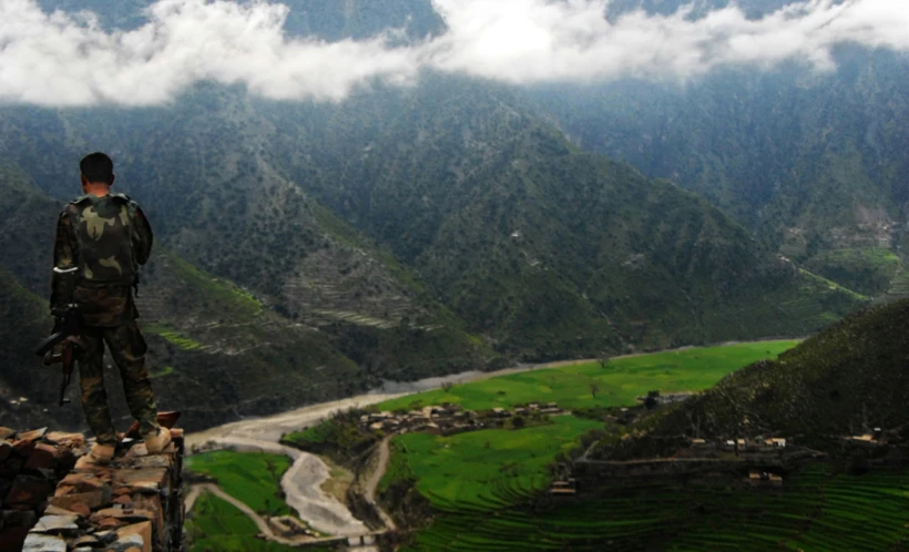 a man looking out over a hilly valley