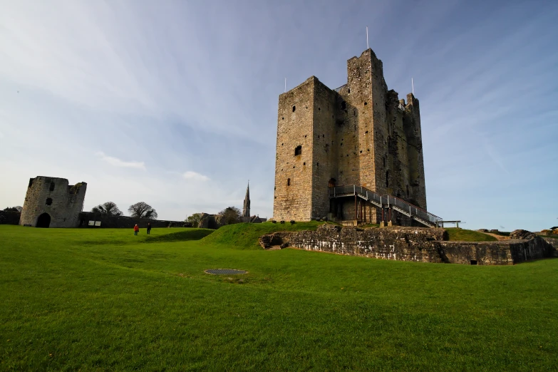 an image of a castle with some people at the bottom of it