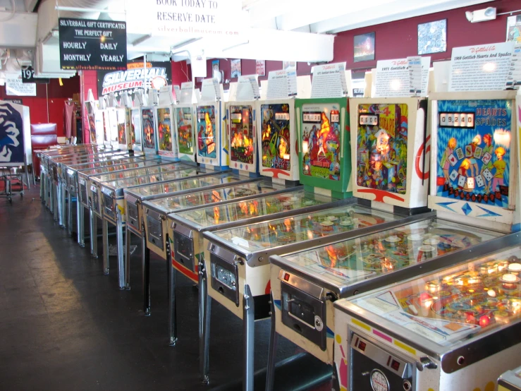 several machines of pinball in an arcade