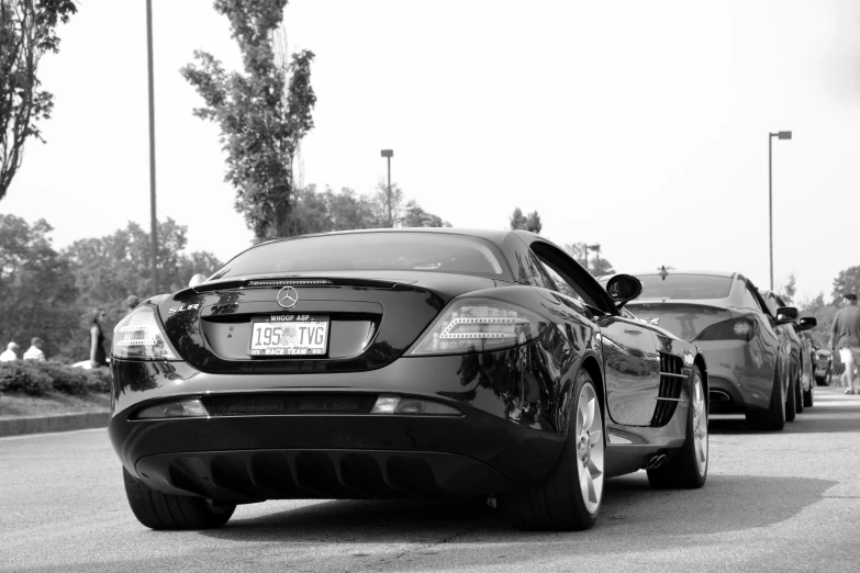 a couple of black cars parked side by side