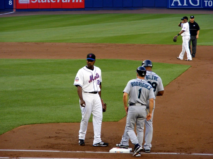 two base ball players are talking to one another