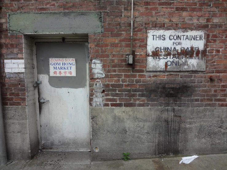 a door sits in front of a dirty building