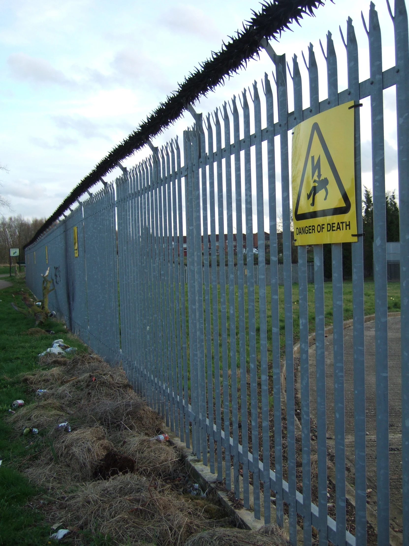 a gate is closed by some barbed wire