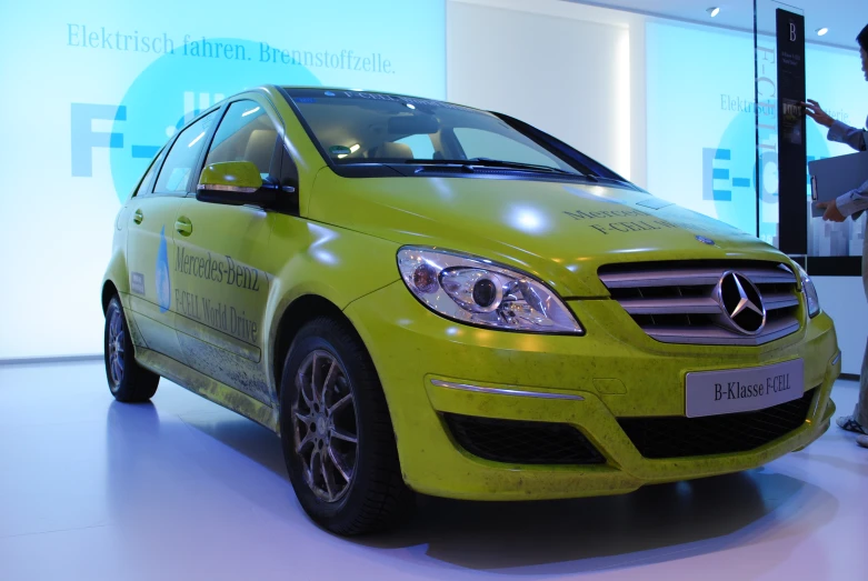 a mercedes benz c - class coupe in lime green