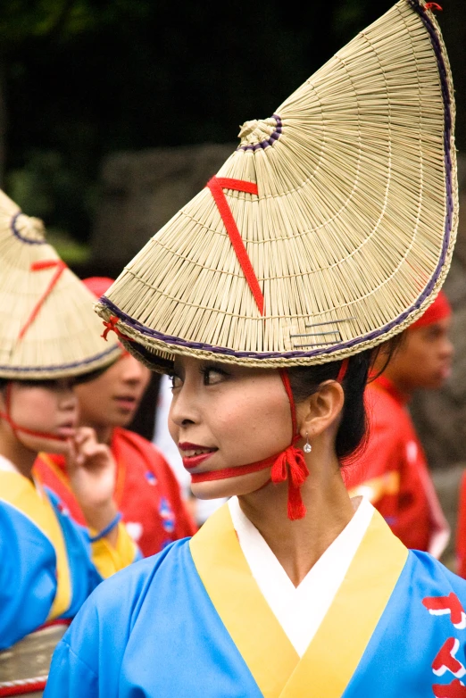 two young women wearing matching hats standing together