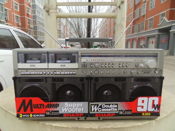 a pair of boomboxes that have been purchased on the sidewalk