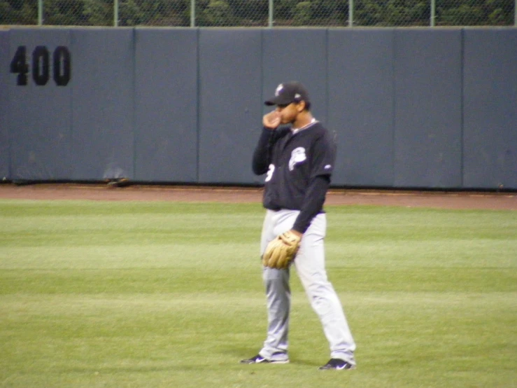 man in a baseball uniform with mitt on his hand