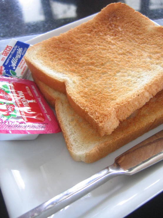 a piece of toast next to a bowl and knife