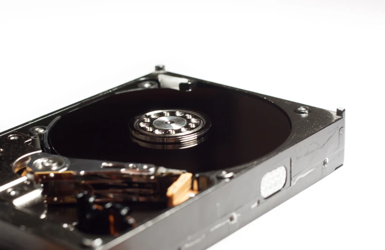 a broken black hard drive is shown against a white background