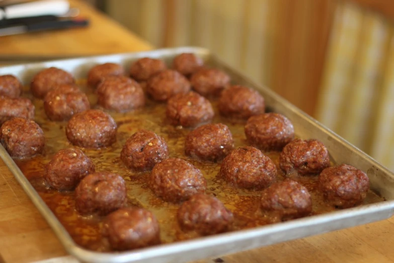 several pieces of meatballs are cooked in oil