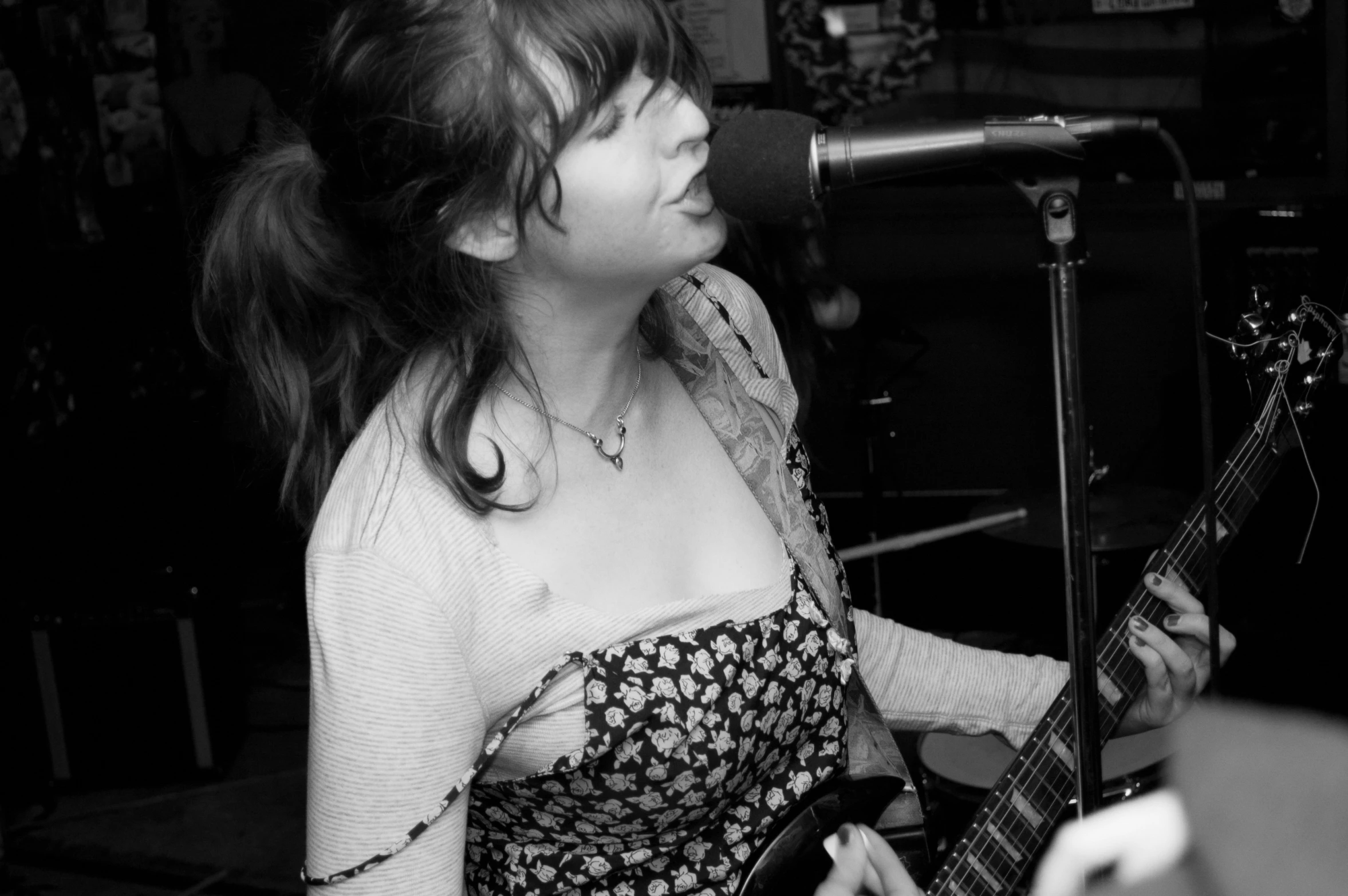 a woman sitting on top of a chair next to a microphone