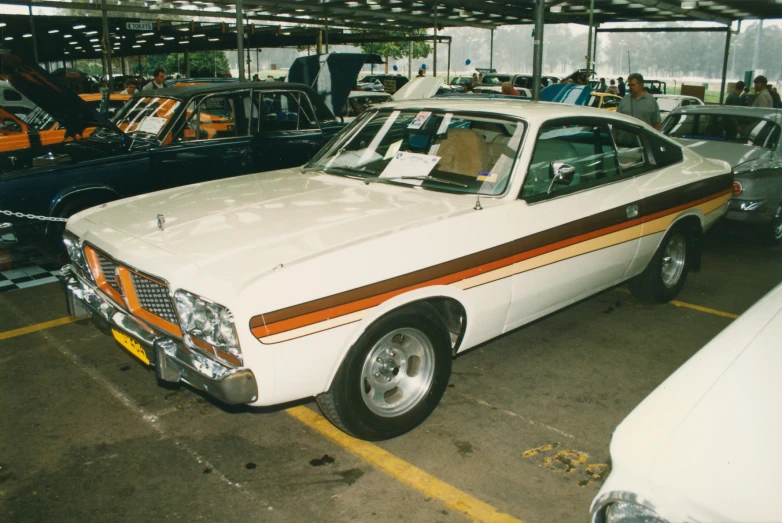 a white car with red stripes parked in a building