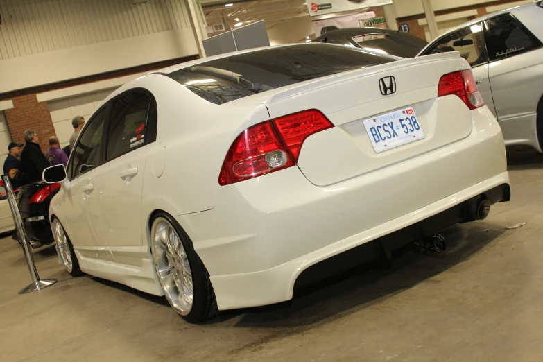 there is a white honda civic in the showroom