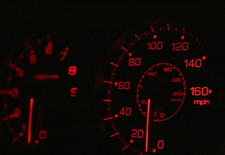 the instruments in a car glow red in the dark