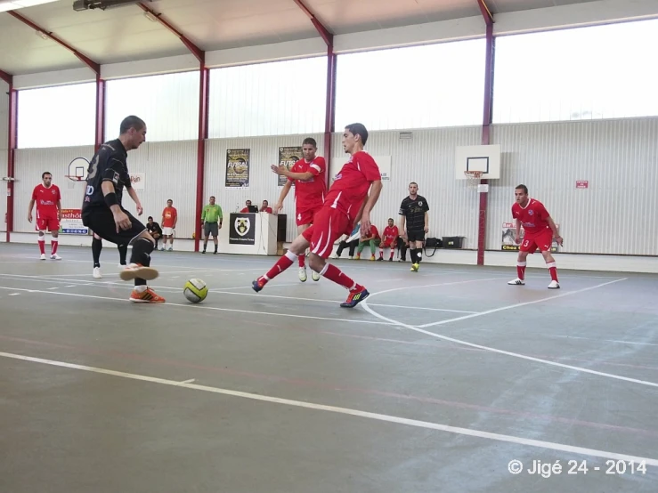 several people are playing soccer on a court