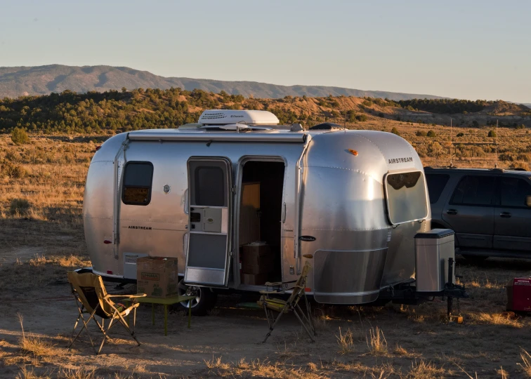 an rv set up on the side of a dirt road