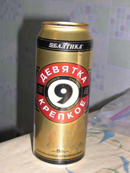 a golden canned bottle that has been placed on top of a table