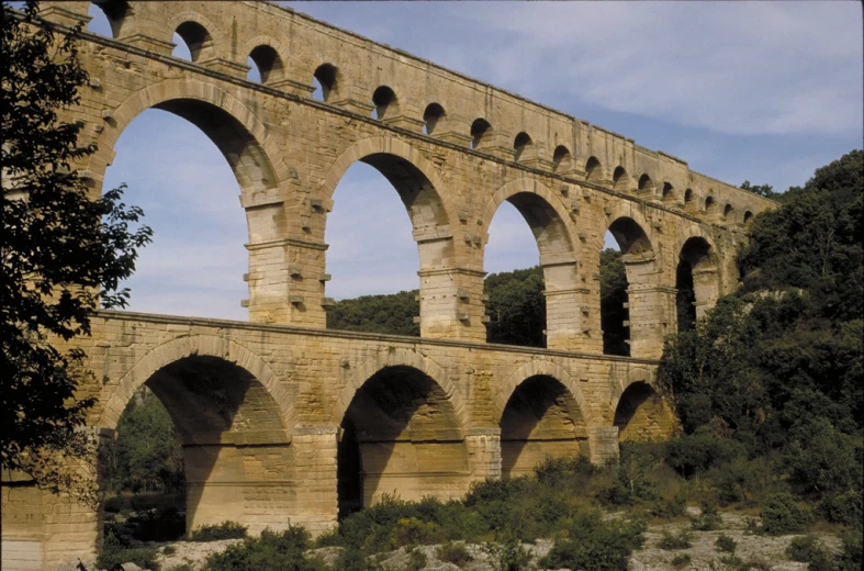 a very large brick bridge with arches over water