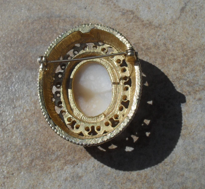 a decorative brooch that is laying on a floor