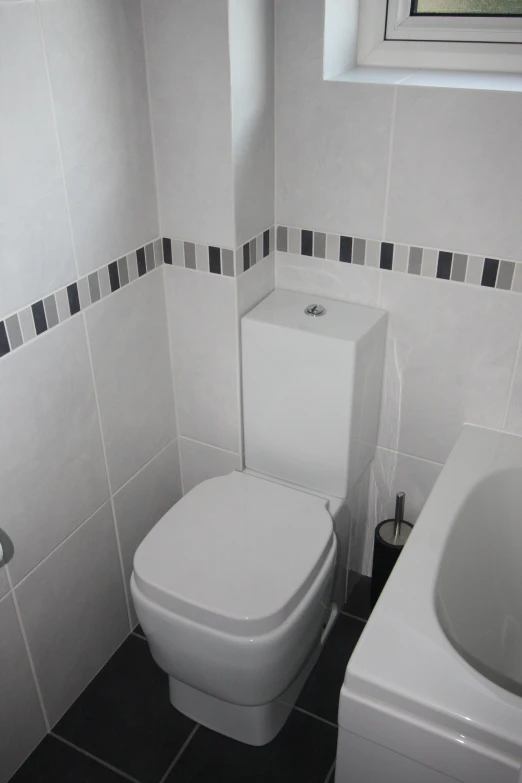 a bathroom with toilet and sink made from cement blocks