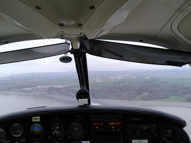 a cockpit view with view of trees and buildings