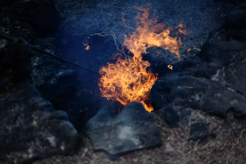 bright orange flames are glowing around a stone structure